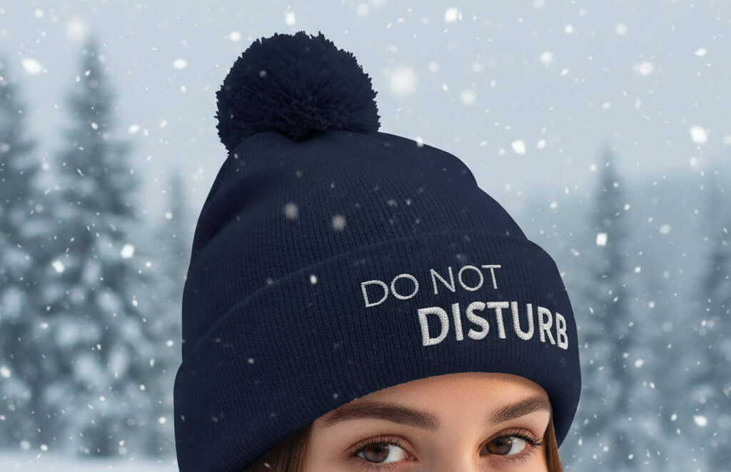 Close up of navy beanie, do not disturb message