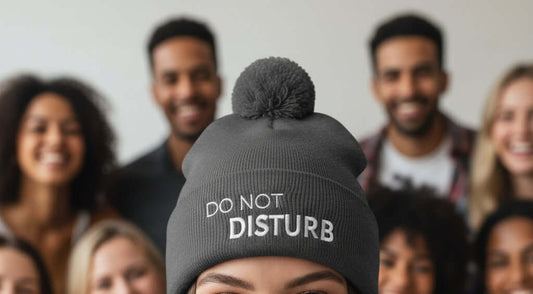 Gray beanie with pom-pom and 'Do Not Disturb' text on a white background