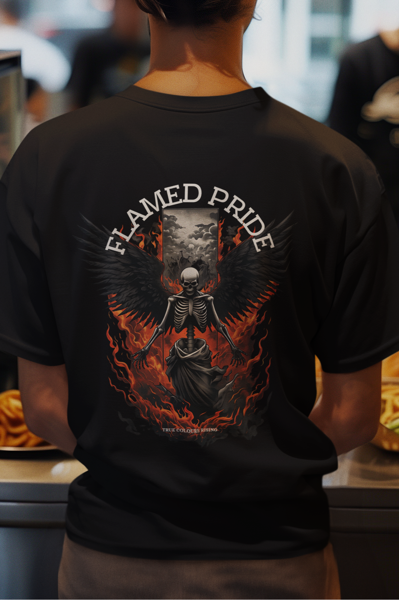 Person wearing a black t-shirt with 'Flamed Pride' design in a fast-food restaurant. lady's t shirt in black