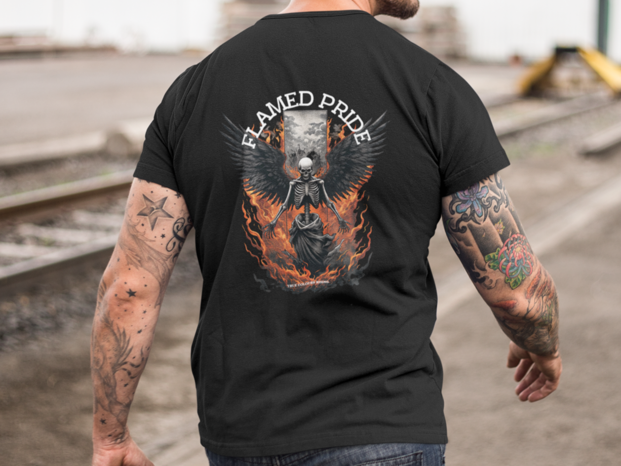 Man wearing a black t-shirt with a graphic design on the back, standing outdoors. Flamed pride from true colours rising unisex
