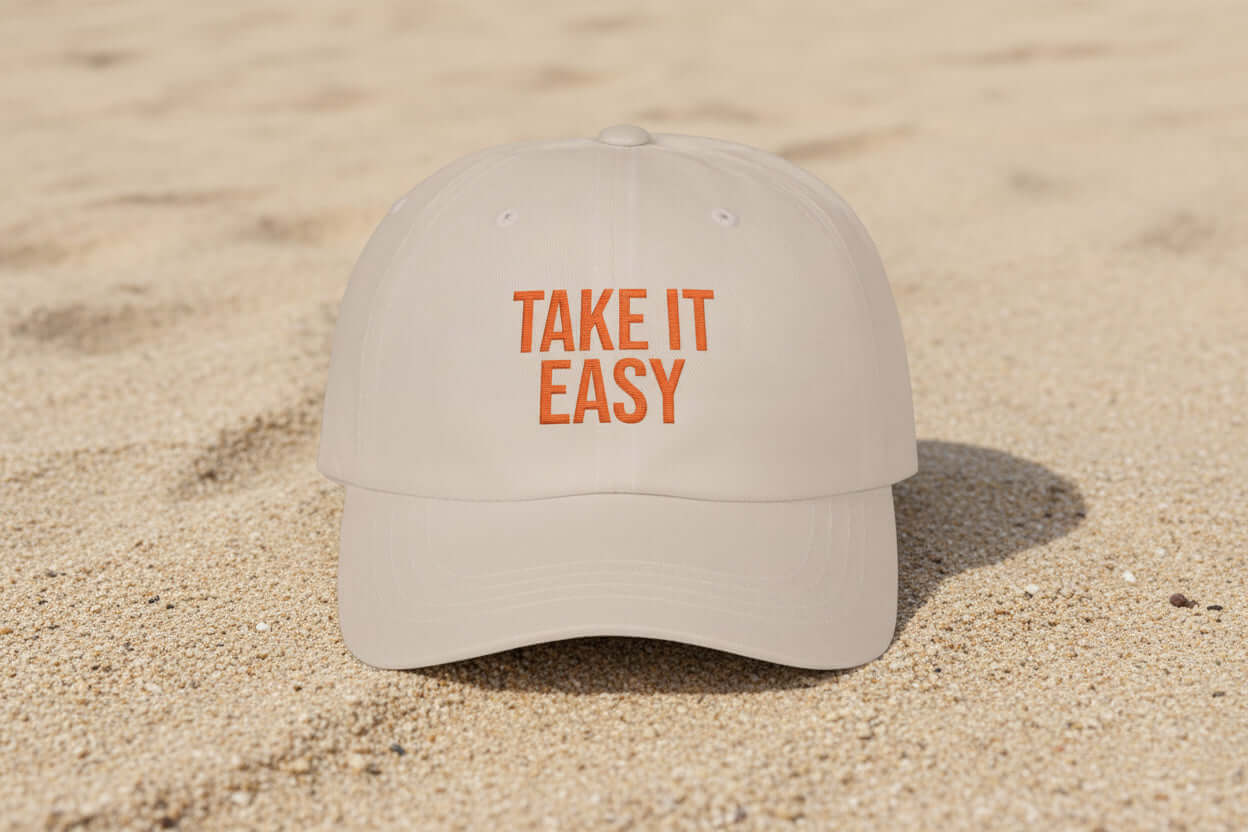 Natural sand dad cap with Take It Easy text worn casually outdoors