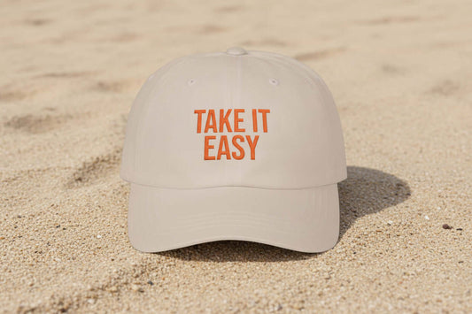 Natural sand dad cap with Take It Easy text worn casually outdoors