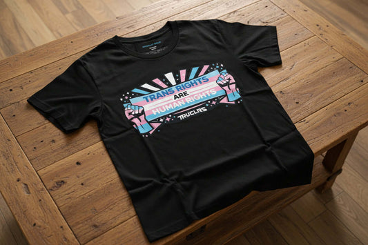 Unisex black activist t shirt supporting transgender rights with bold banner artwork