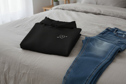 She Is Mine Black Hoodie Folded black hoodie with a heart and arrow design on a white background