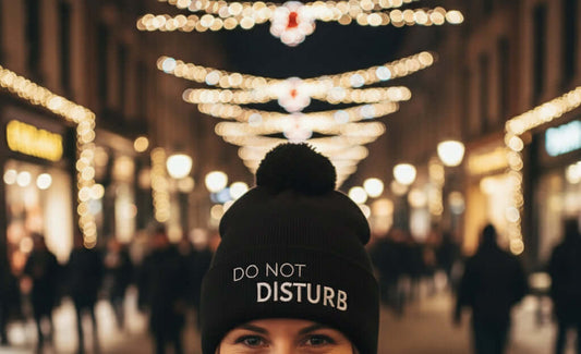 Stylish black winter bobble hat with embroidered slogan