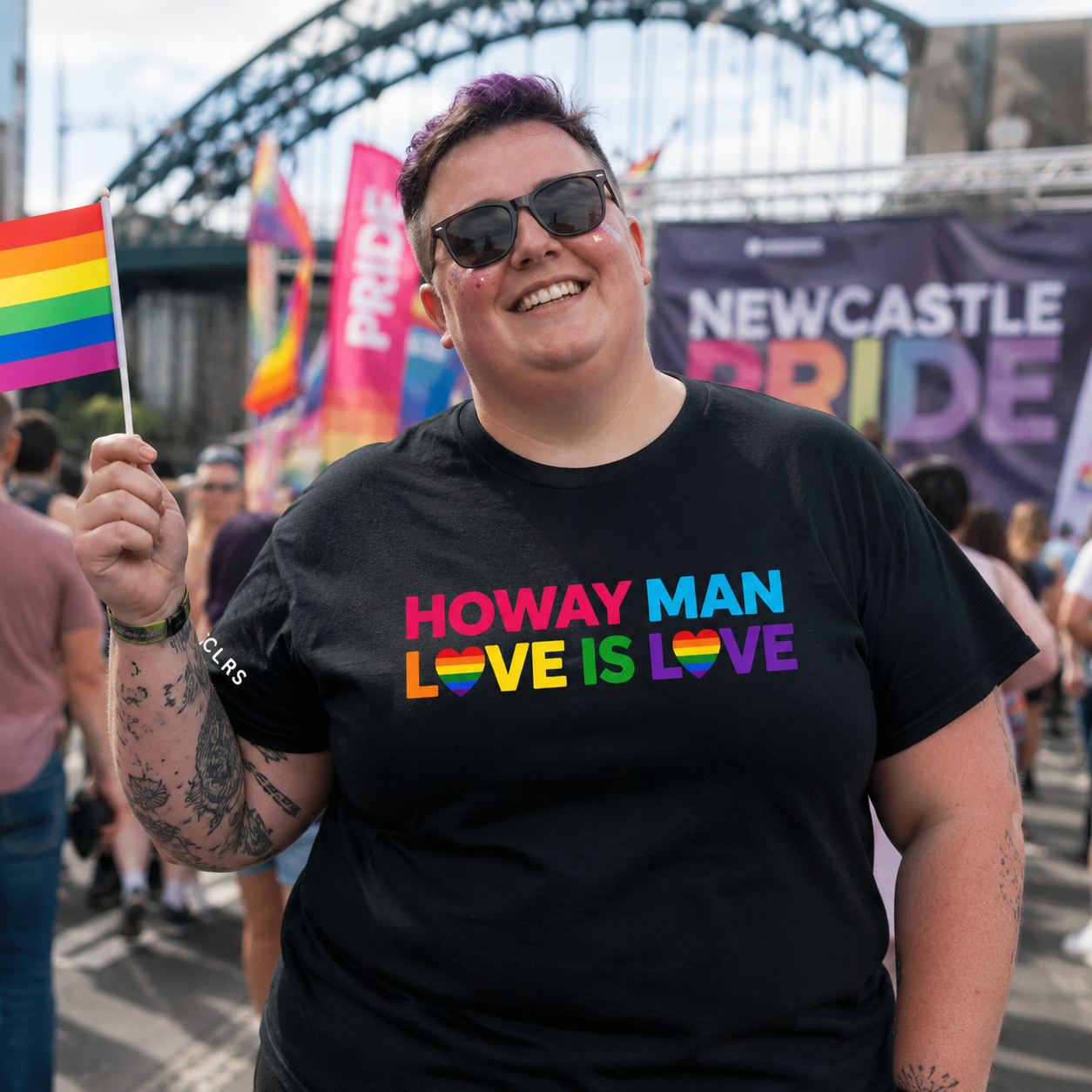 Plus-size and diverse women wearing TRUCLRS Pride apparel at a colourful LGBTQ+ celebration.