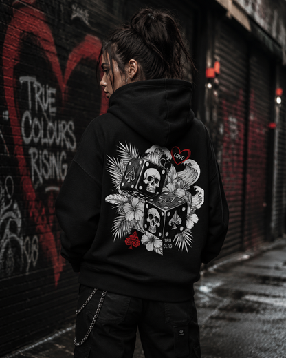 Love Is a Gamble premium black hoodie styled in an urban London setting with red buses and city streets.