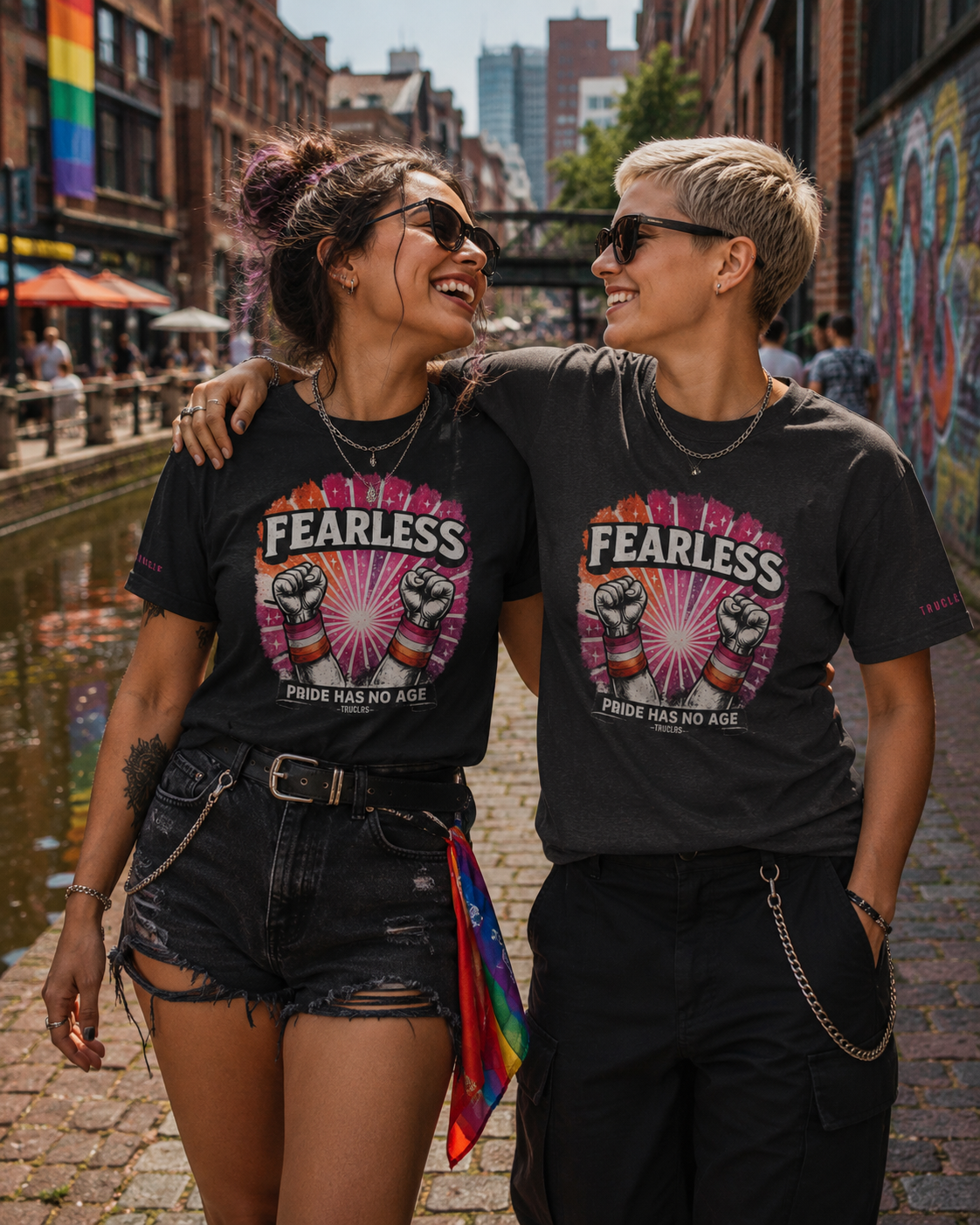Queer women laughing together in Manchester Canal Street wearing Fearless Souls graphic tees