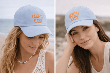 Woman wearing Take It Easy dad cap holding a mug by the shoreline, relaxed lifestyle look