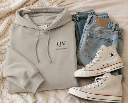 Queer Vintage Timeless Spirits hoodie in ash grey featuring a minimalist QV logo with Timeless Spirits text on the left chest.