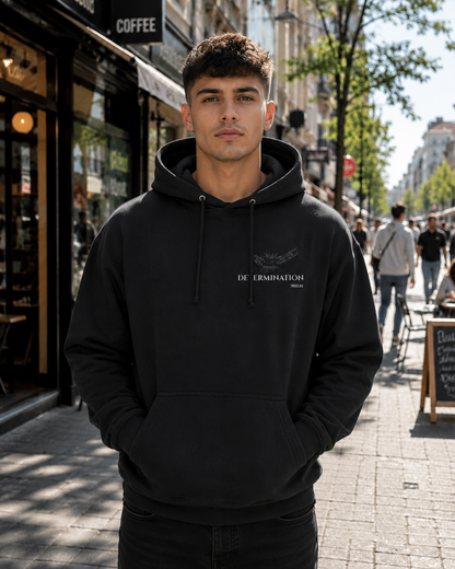 IMPOSSIBILITY BECOMES POSSIBLE WITH DETERMINATION premium jet black unisex hoodie featuring a subtle broken chain chest motif with Determination and TRUCLRS branding.
