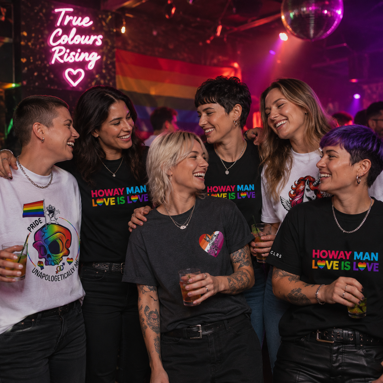Group of lesbian women celebrating Pride in a nightclub wearing TRUCLRS Pride T-shirts with rainbow designs and inclusive messages.