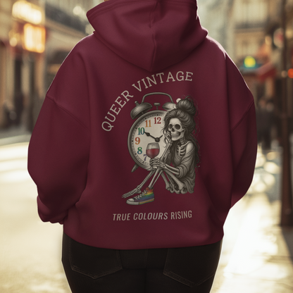 Queer Vintage -True Colours Rising Skeleton Clock Hoodie showing skeleton holding wine glass beneath rainbow clock design