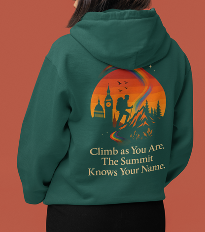 Queer pride hiking hoodie featuring mountain silhouette, rainbow path, and motivational summit quote