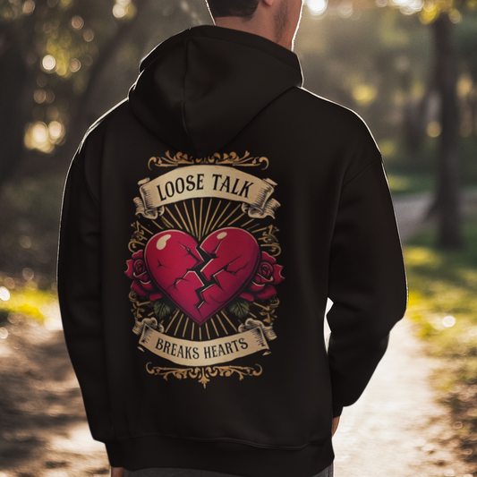 Person wearing a black hoodie with a vintage tattoo broken heart in the park