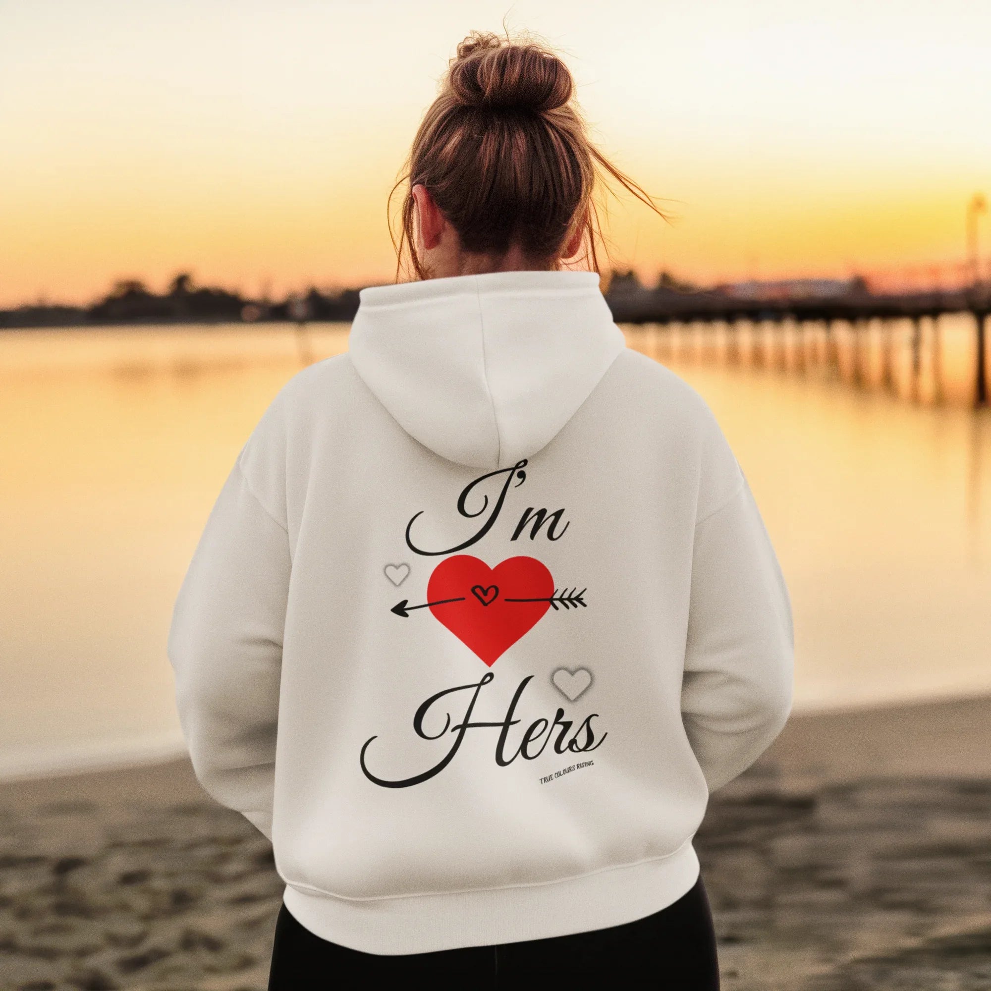 I'm Hers Matching White Hoodie with stylish design, featuring bold text and heart graphic, set against a sunset beach background.