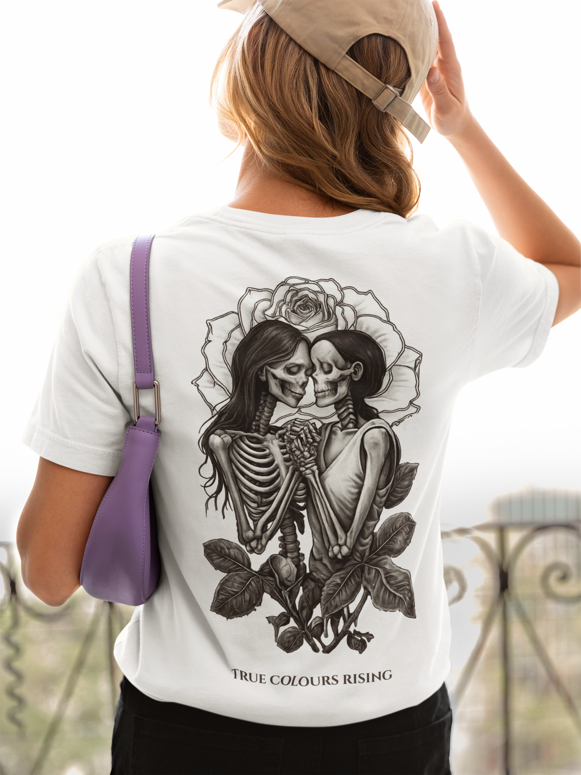 Love Undying T Shirt  White T-shirt featuring gothic skeleton lovers artwork with rose background and True Colours Rising branding