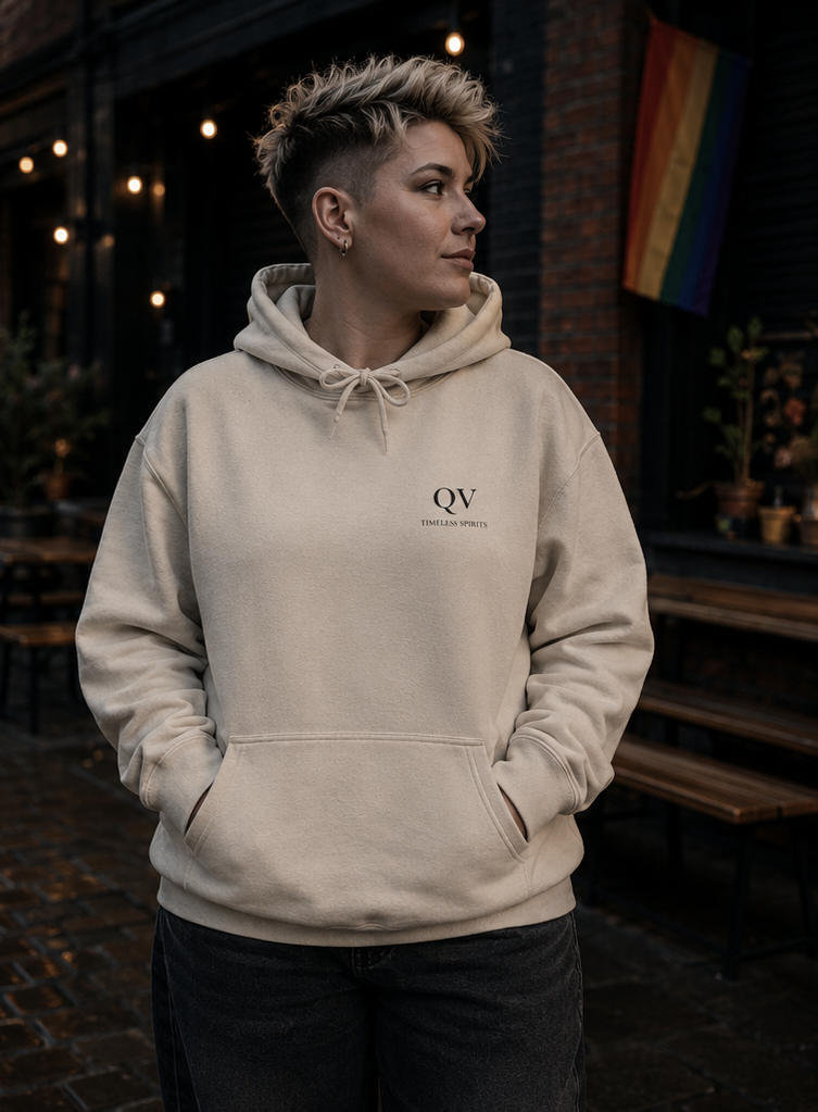 Front view of the Queer Vintage Timeless Spirits hoodie featuring the minimalist QV chest motif.