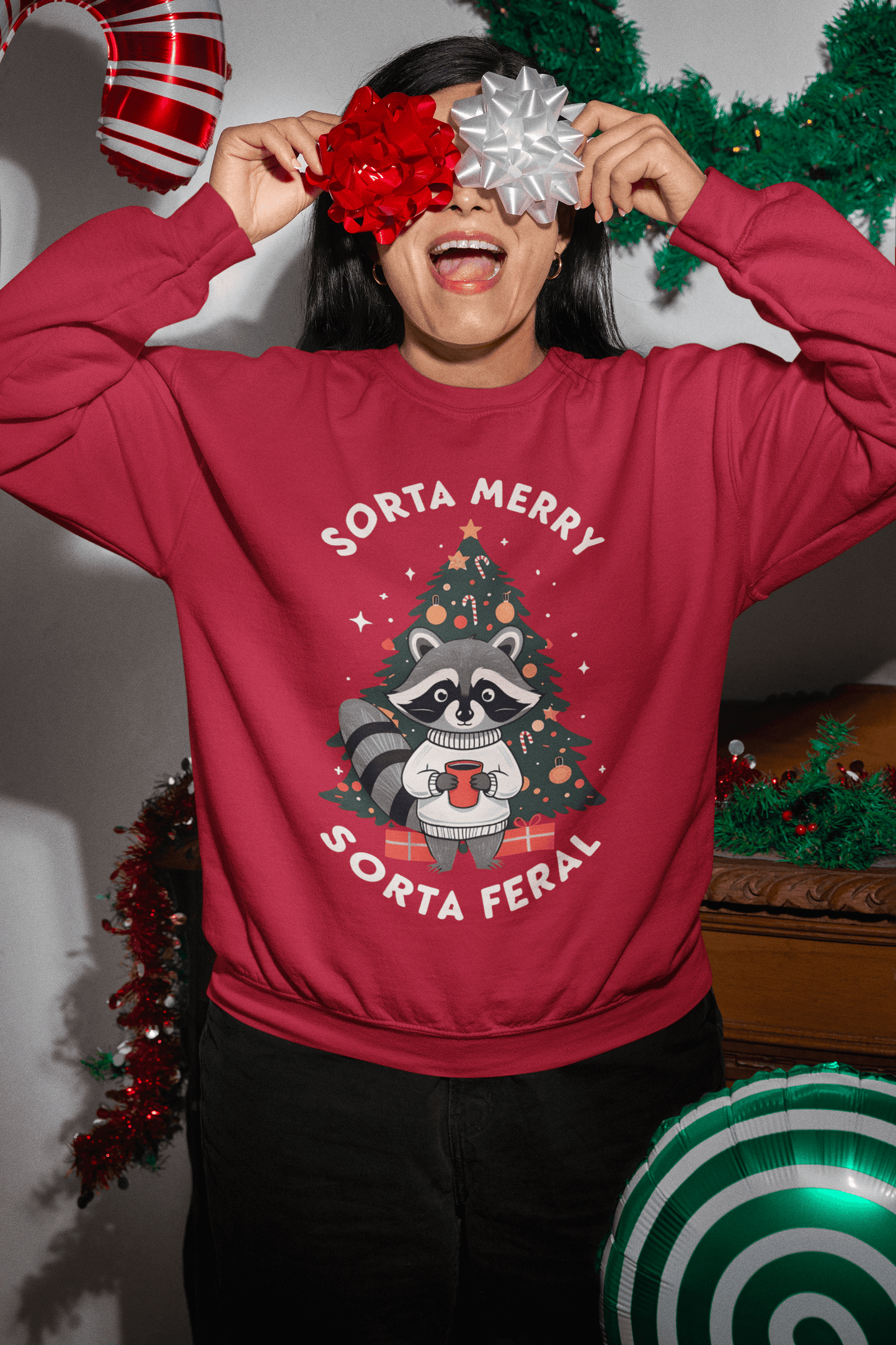 A person wearing a Sorta Merry Sorta Feral Christmas Jumper with a raccoon design, festive decorations around them.
