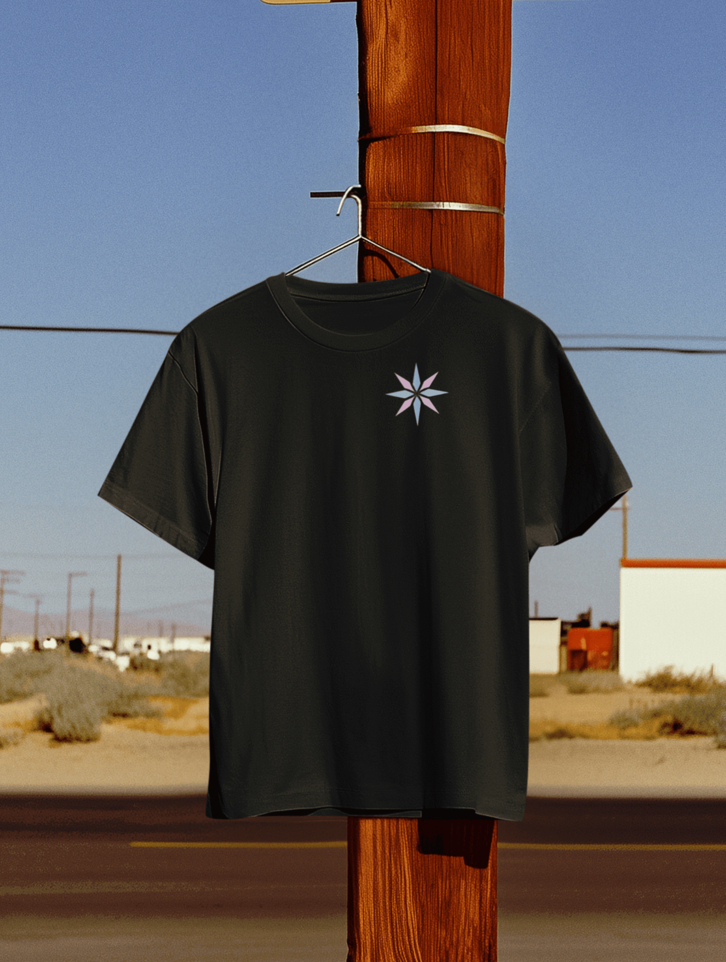 Minimalist black tee featuring a subtle trans pride asterisk star design