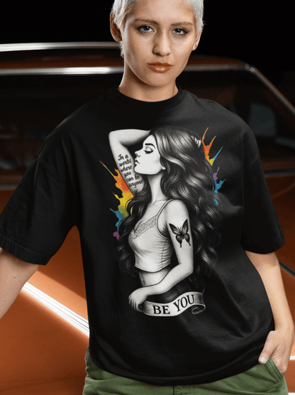 Model wearing a Be You - Reimagined T-shirt featuring a bold illustration of individuality.