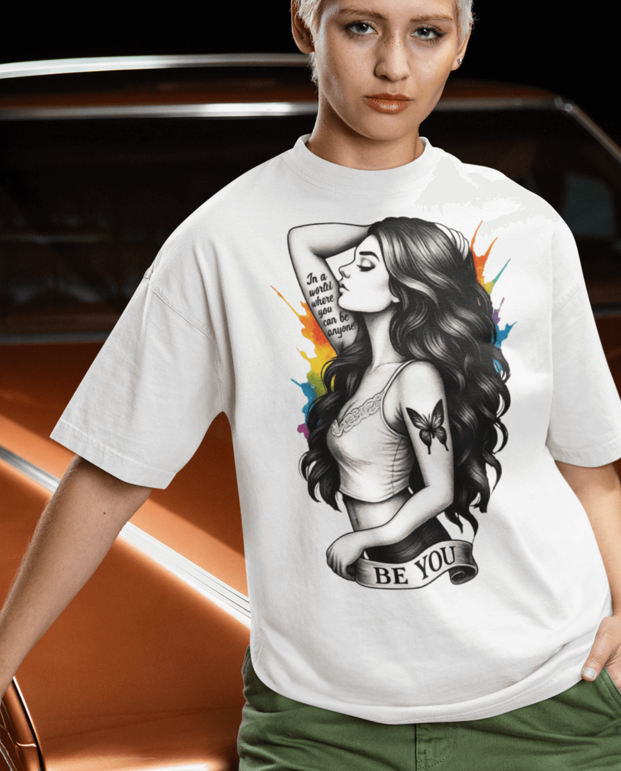 Model wearing the Be You - Reimagined T-shirt featuring a bold illustration and vibrant design.