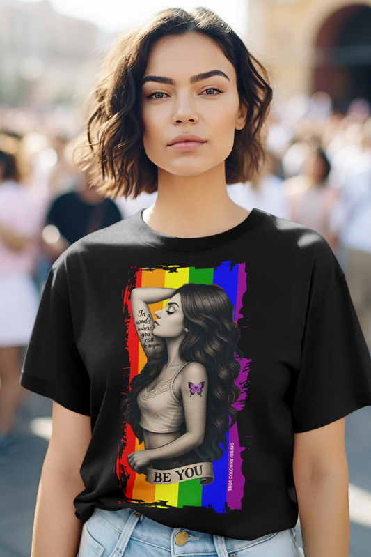 Queer empowerment shirt with rainbow background and Be You message by True Colours Rising.