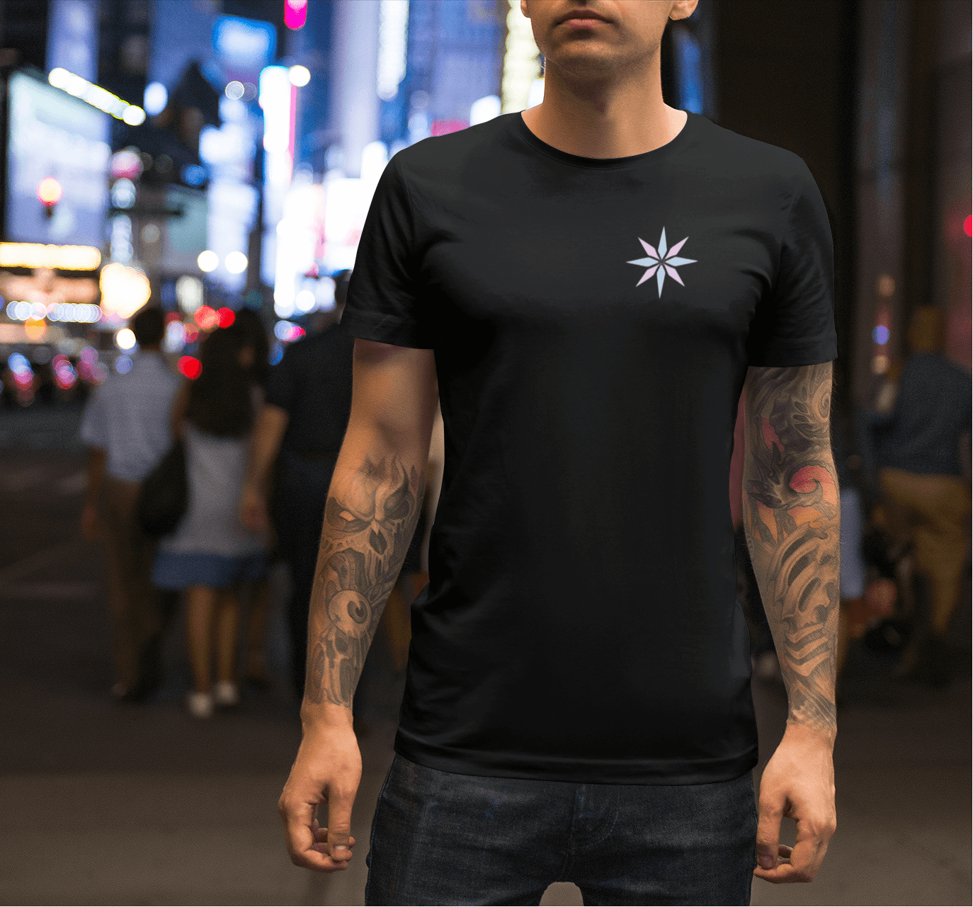 Black t-shirt with a small pastel asterisk star symbol printed over the left chest
