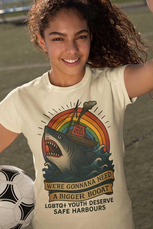 Person wearing a t-shirt with a shark graphic and text on a sports field. Jaws Quote. LGBTQ+ 

